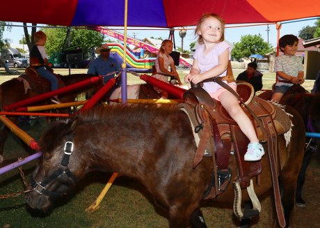A young lady enjoys a horse ride.